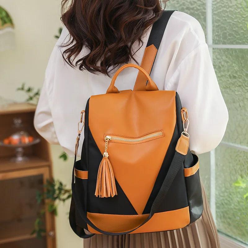 Chic Two-Tone Backpack with Stylish Tassel Pendant
